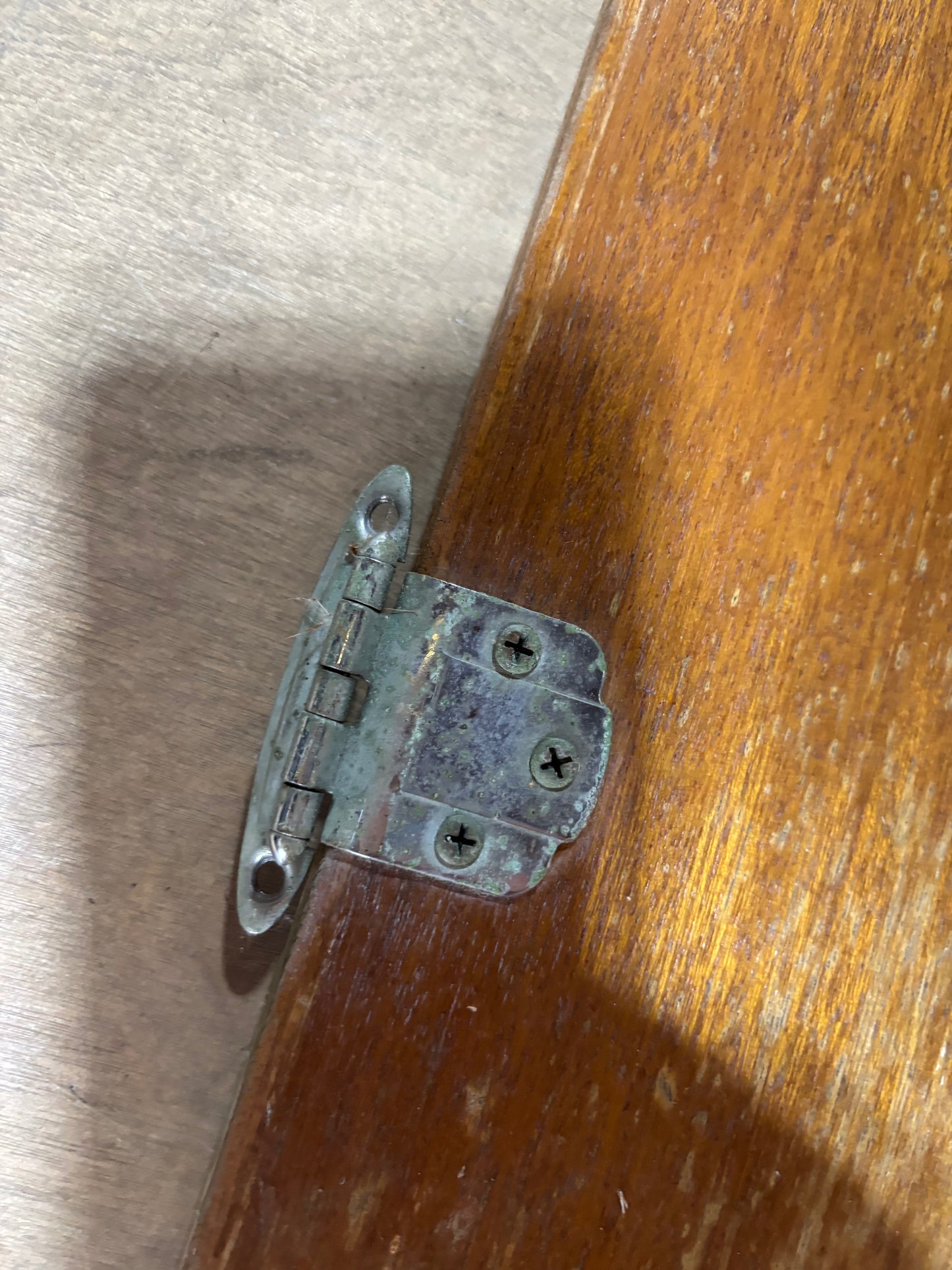 Metal hinge on a wooden surface