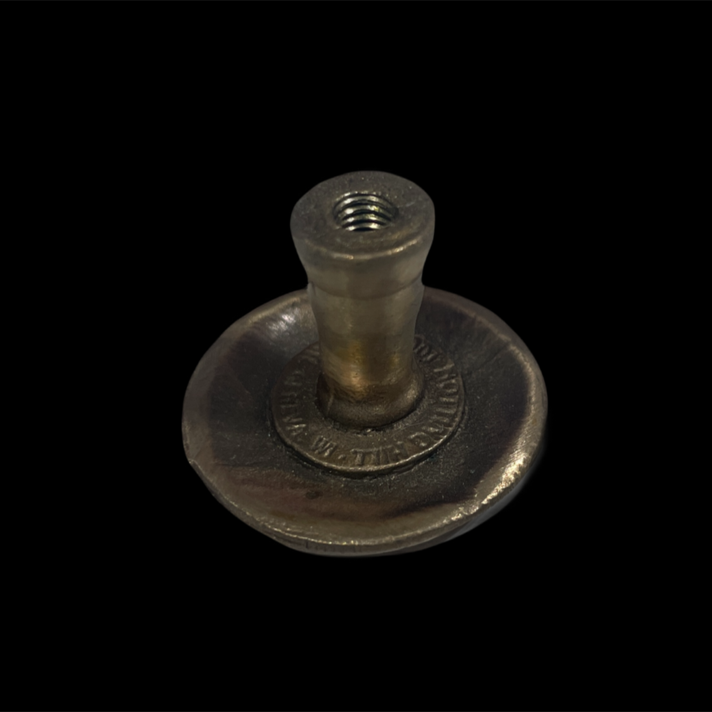 Metal fitting on a black background