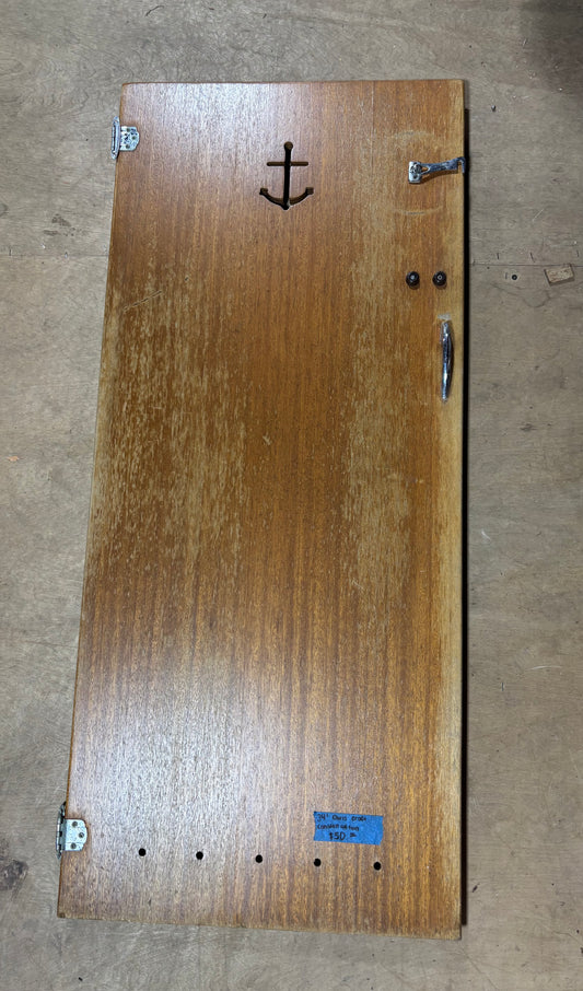 Wooden board with an anchor emblem on a concrete floor