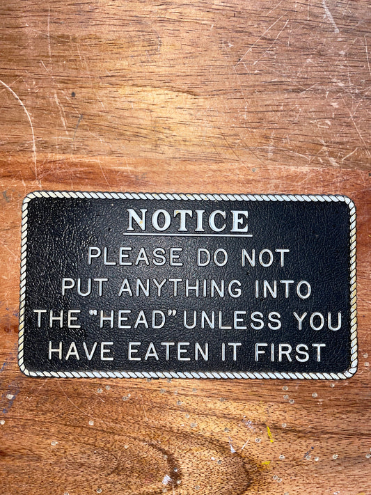 Plastic “NOTICE - Please Do Not Put Anything Into The “Head” Unless You Have Eaten It First” Plaque