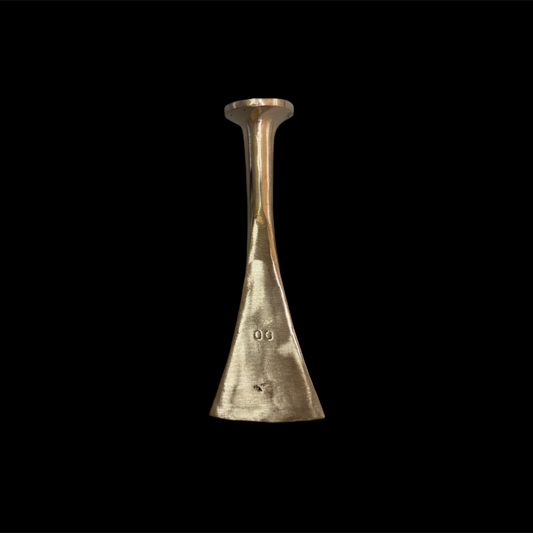 Gold-colored metal object on a black background