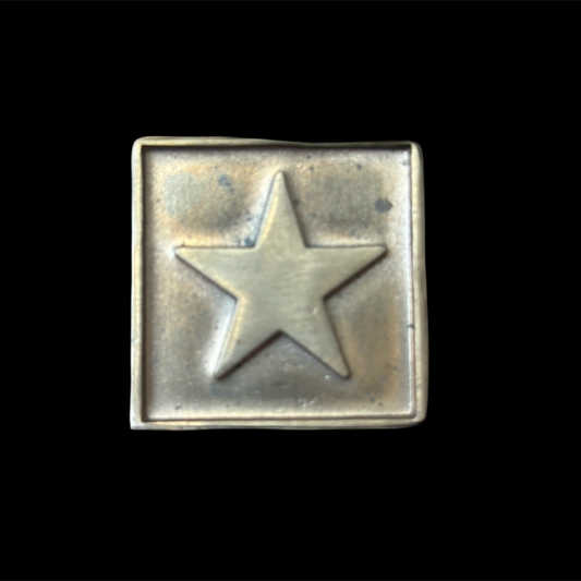 Metallic star-shaped object on a black background