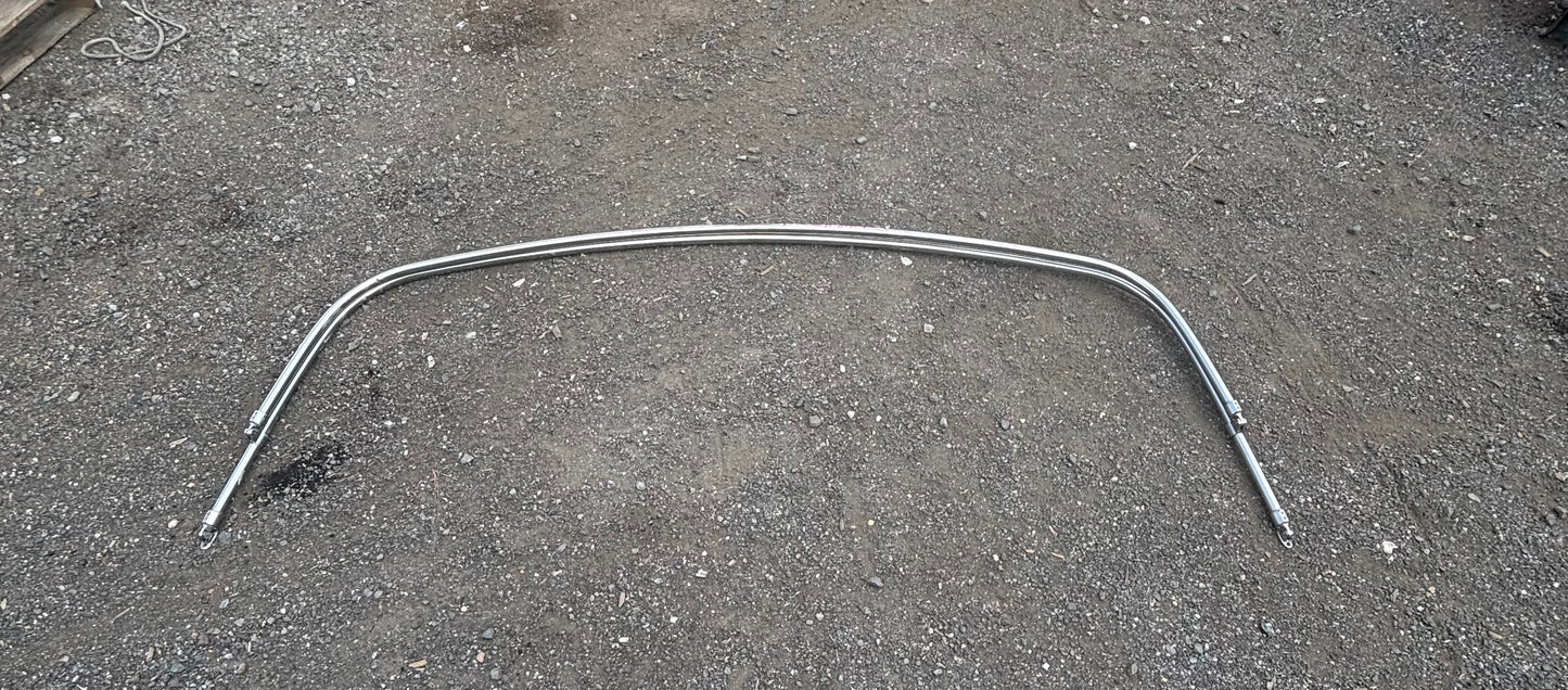 Metallic curved rod on a textured gray surface