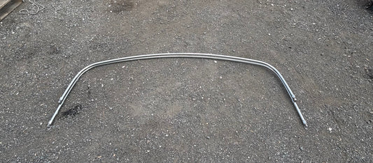 Metallic curved rod on a textured gray surface