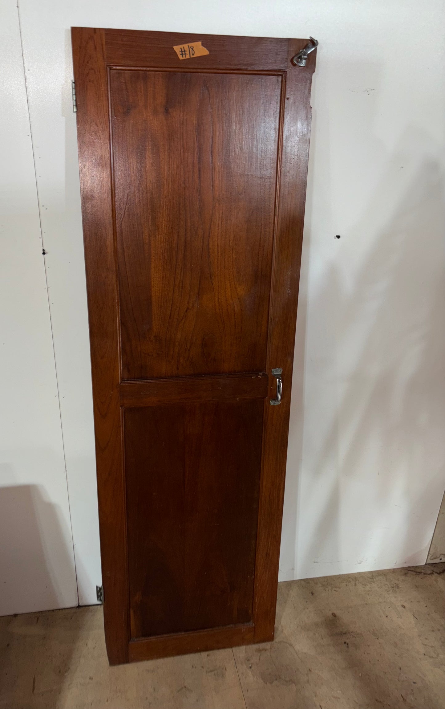 Wooden door with a lock on a white wall