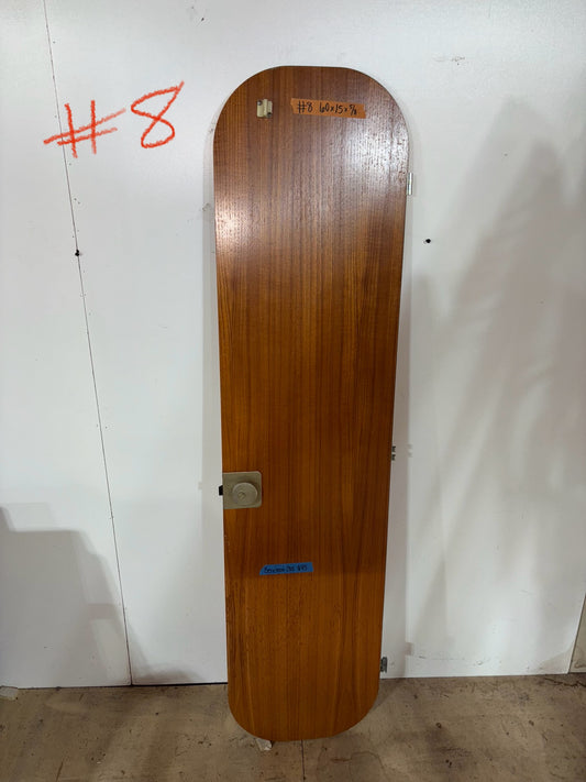 Wooden skateboard deck with visible branding on a white wall.