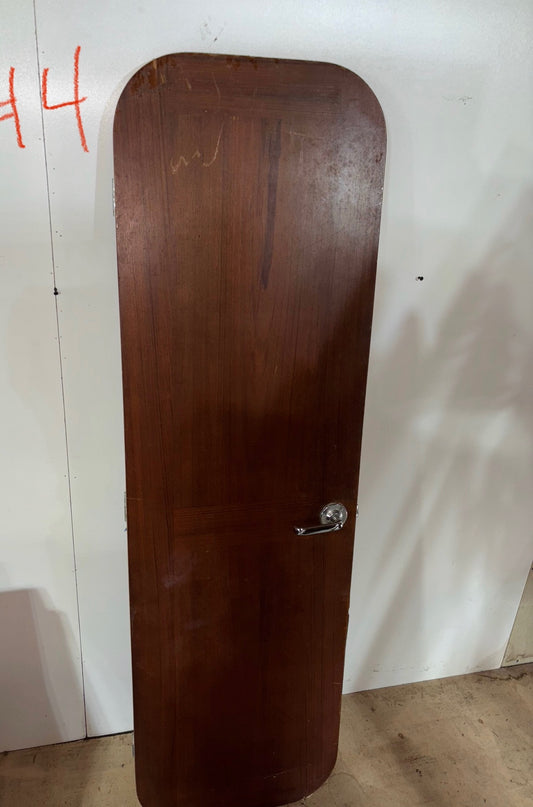 Wooden door with a doorknob on a white wall