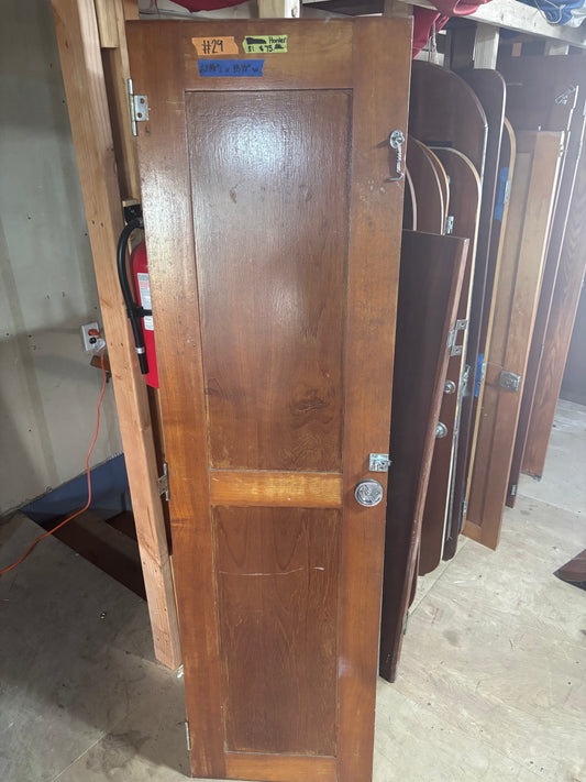 Wooden door with a visible brand label on a warehouse floor.