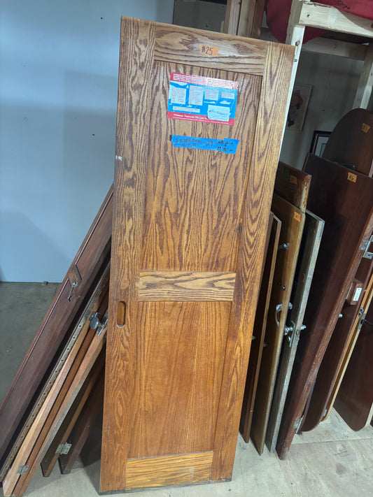 Stack of wooden doors with labels in a storage area