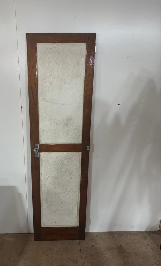 Wooden door with glass panels against a white wall