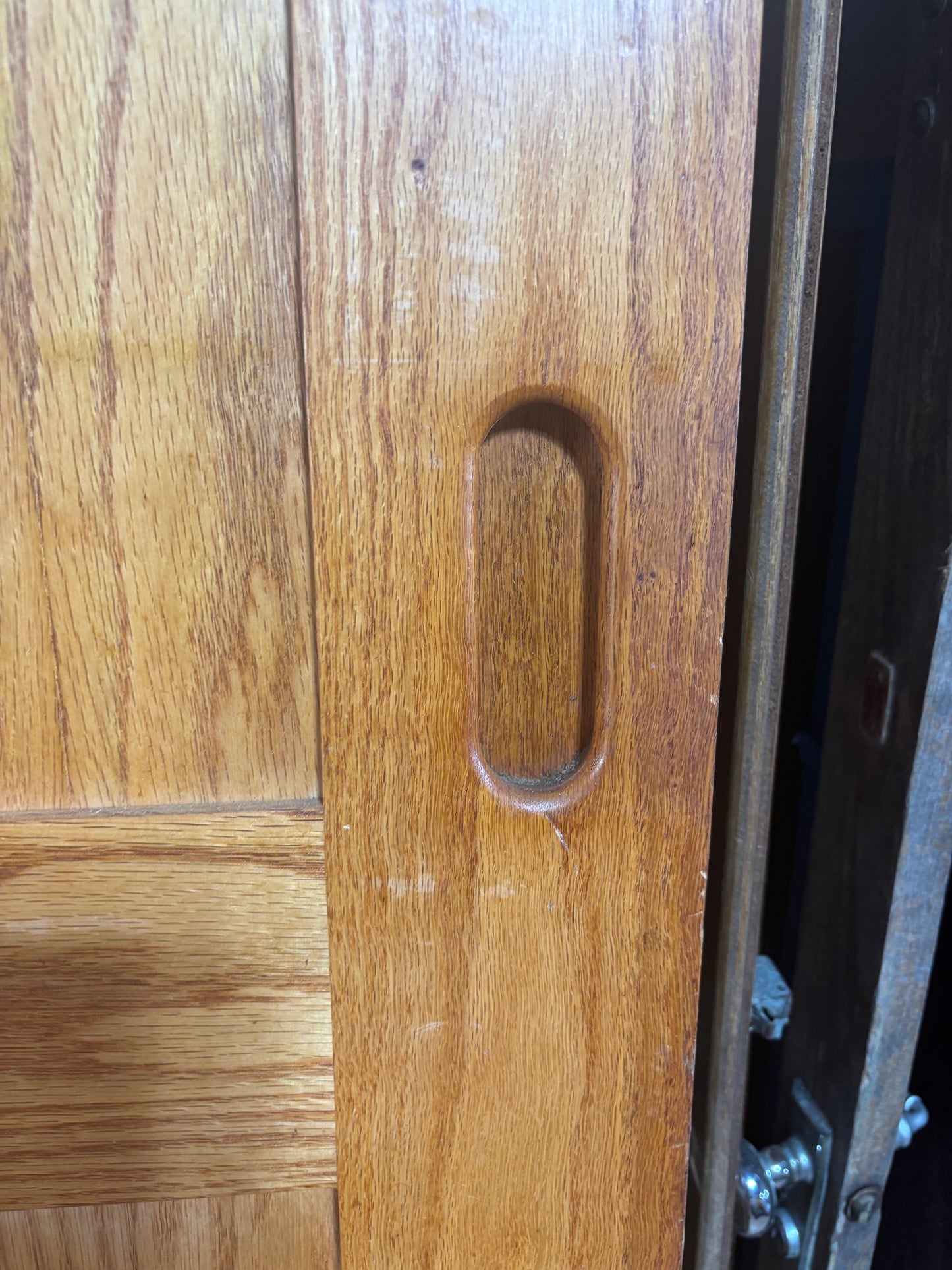 Close-up of a wooden door with a metal handle
