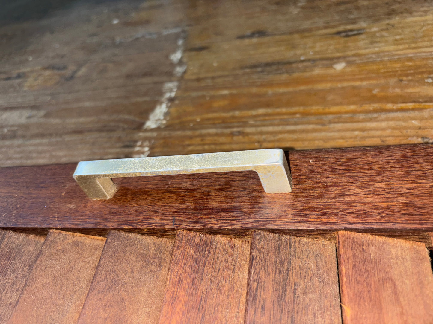 Wooden drawer handle on a wooden surface