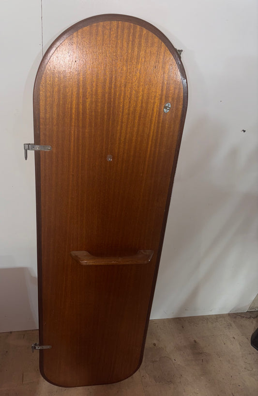 Wooden guitar case against a white wall