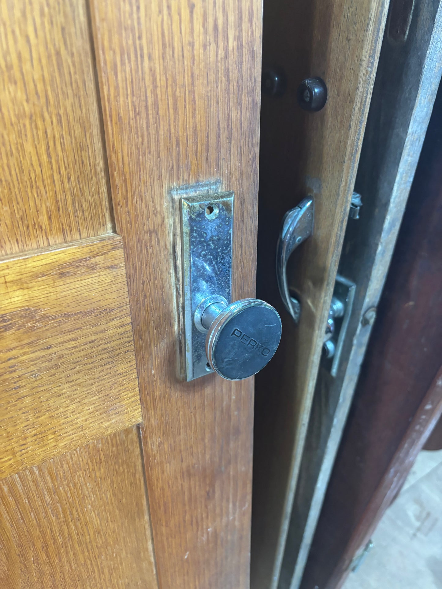 Close-up of a wooden door with a metal handle and lock
