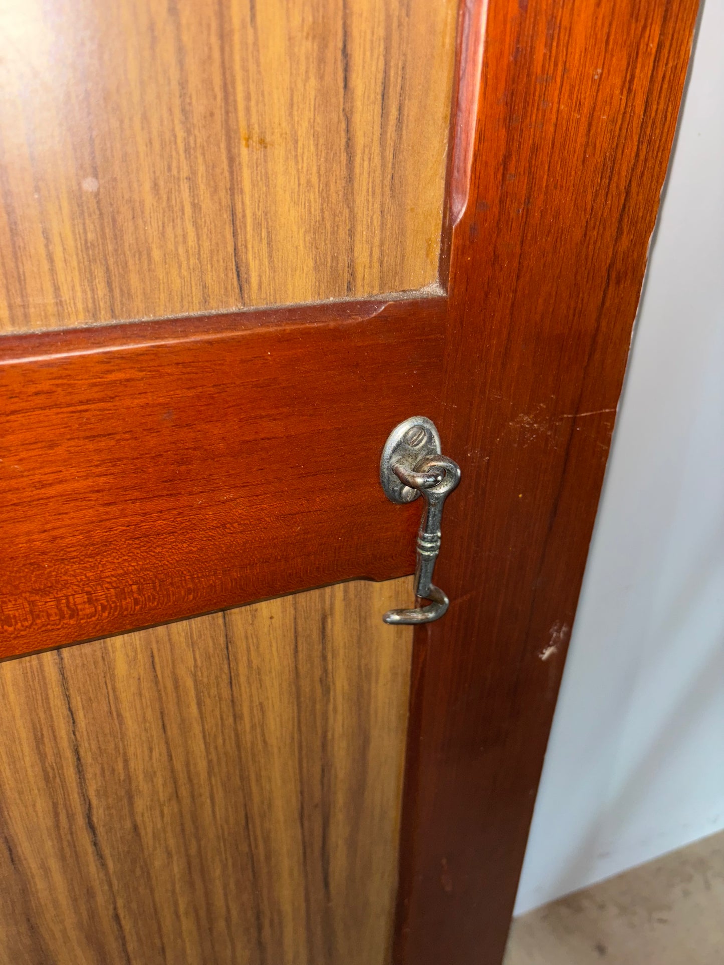 Wooden door with a decorative lock on a plain background
