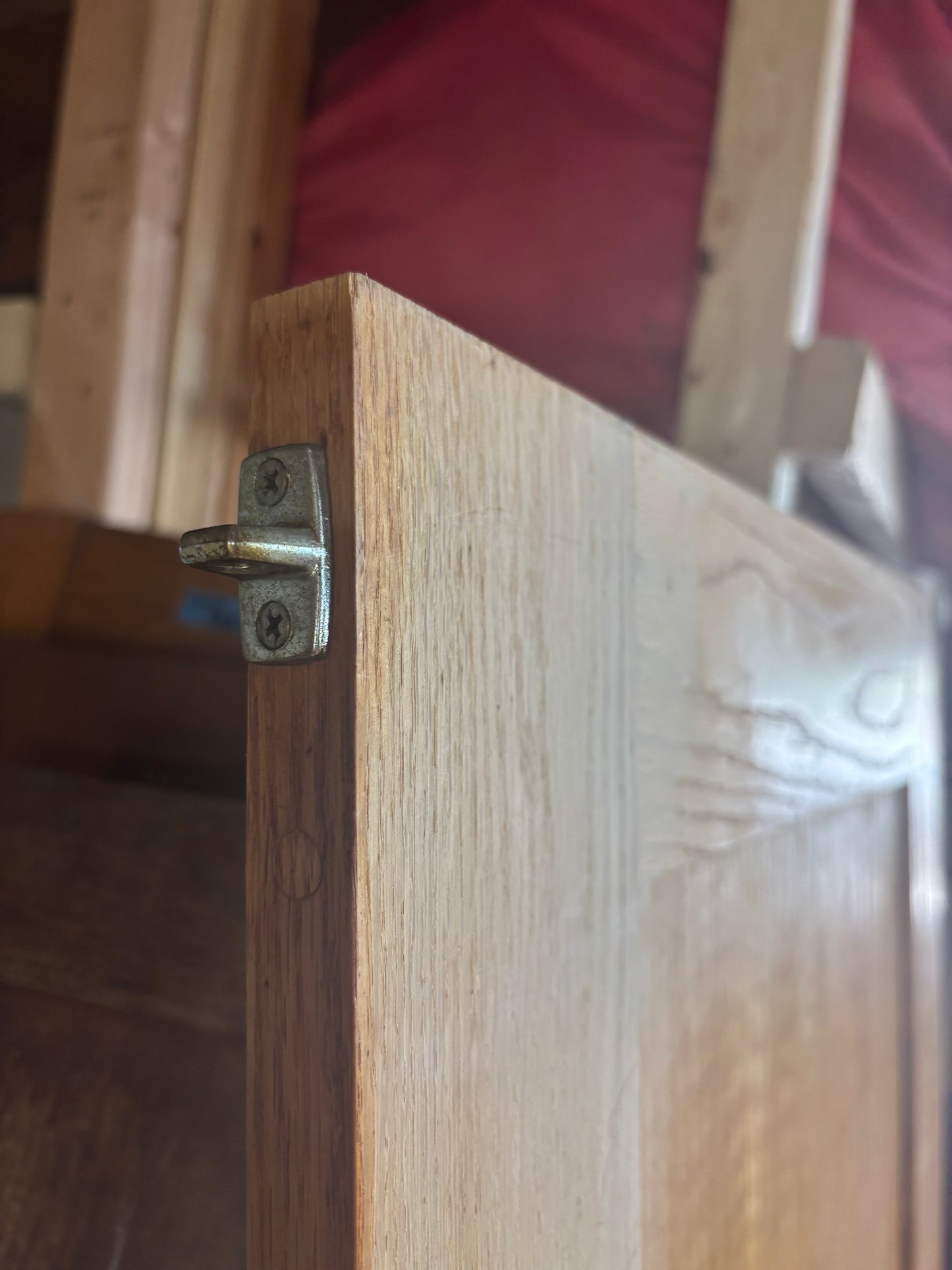 Wooden door with a metal latch on a blurred background
