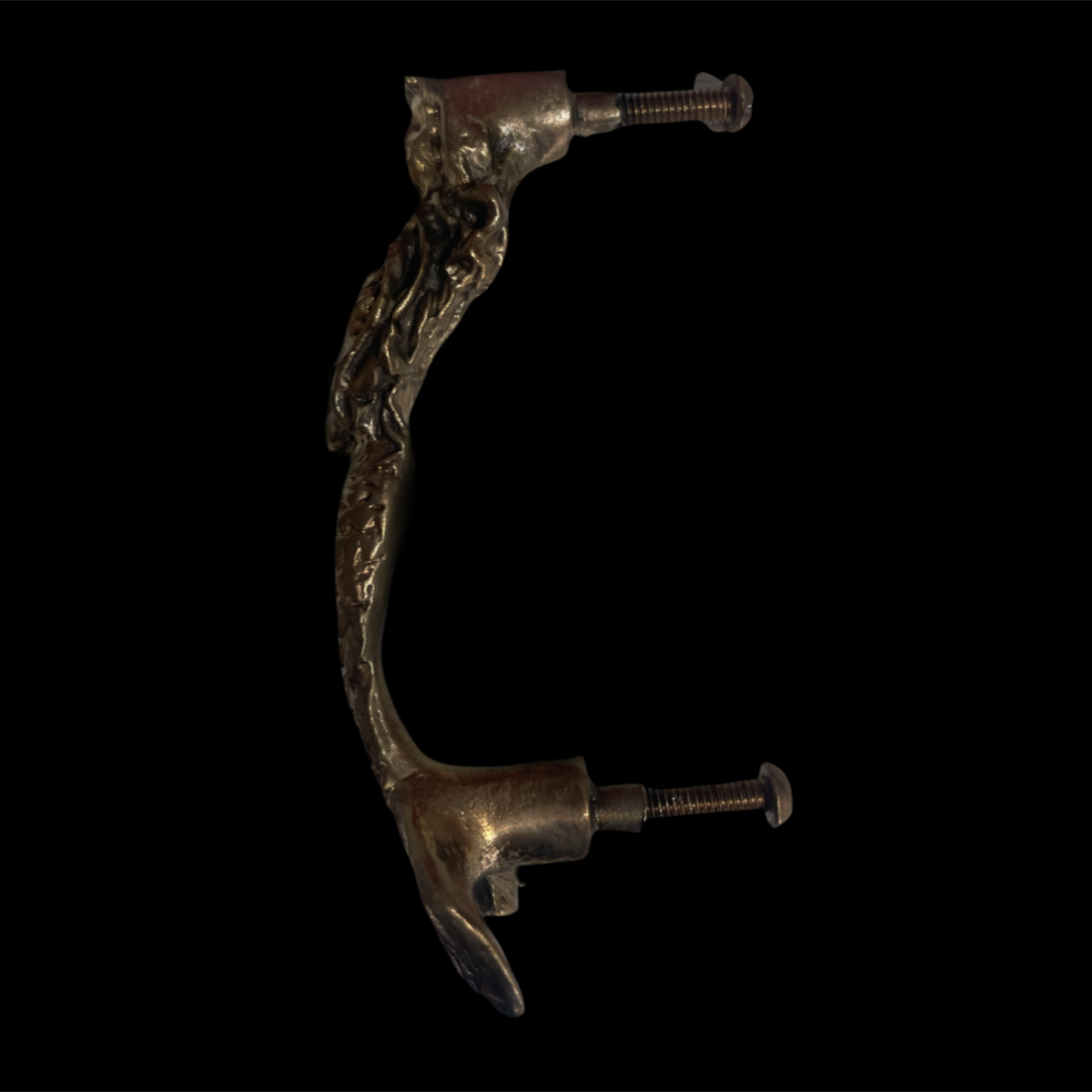 Decorative metal handle with intricate designs on a black background