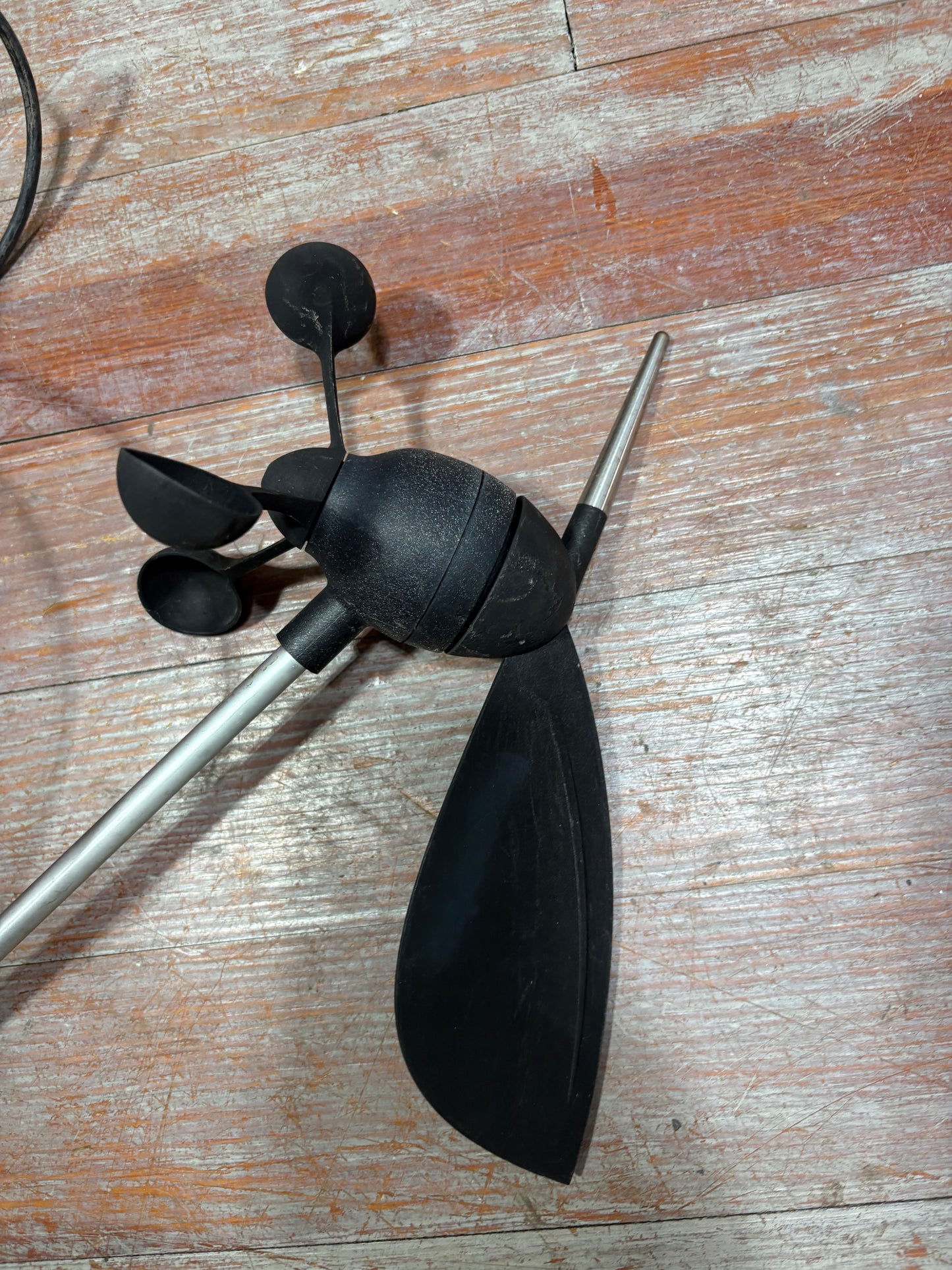 Black anemometer on a wooden surface