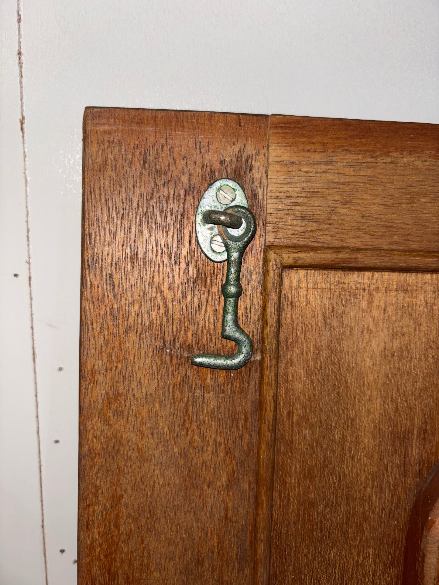 Wooden door with a metal handle and lock on a white background