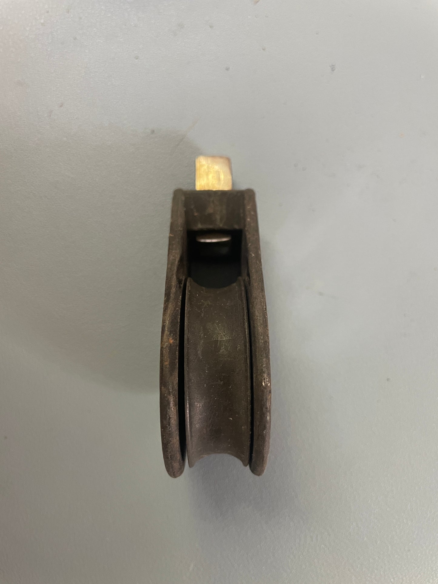 Metal pulley system on a gray background