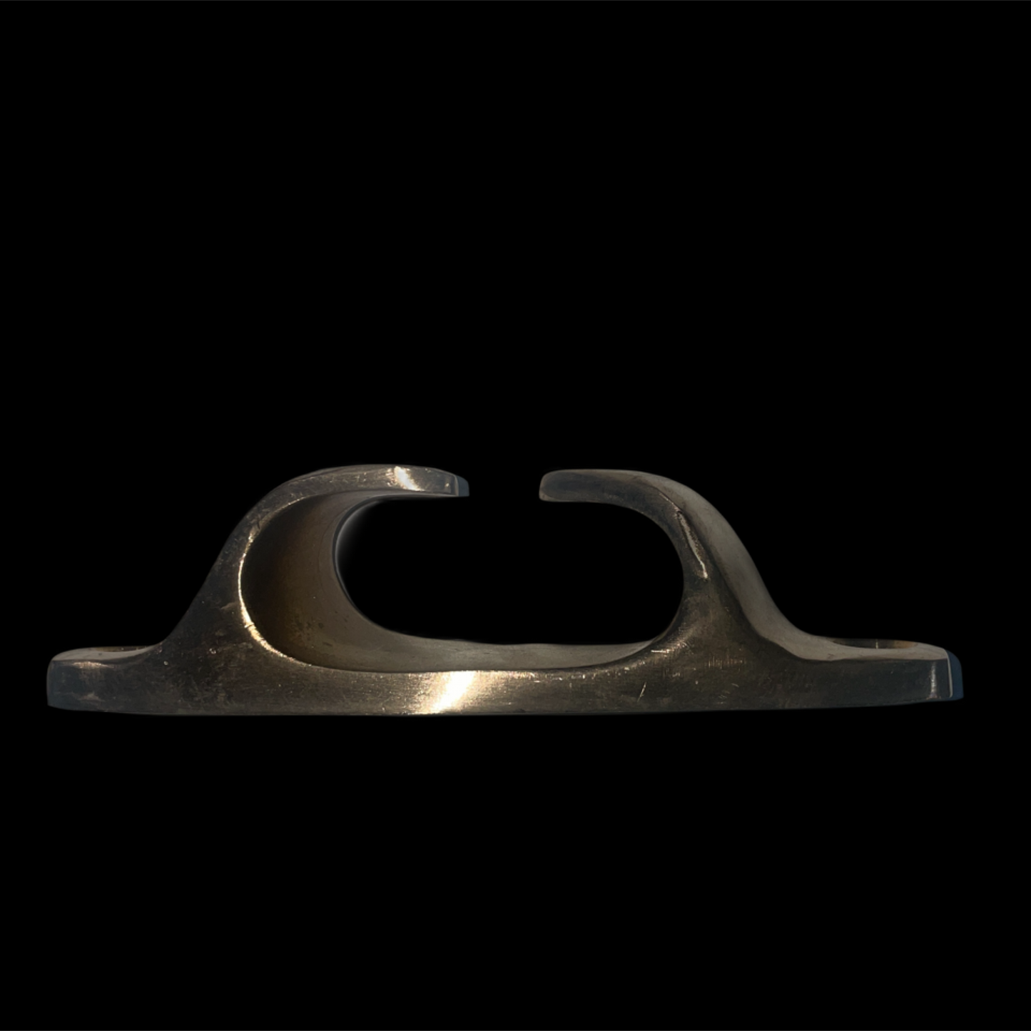 Metallic object with a U-shaped design on a black background
