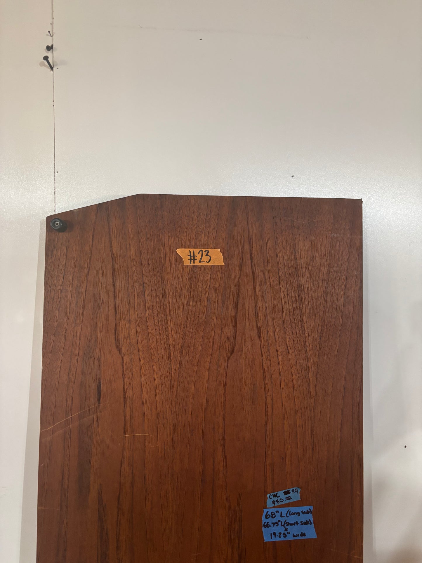Wooden panel with a label on a white wall