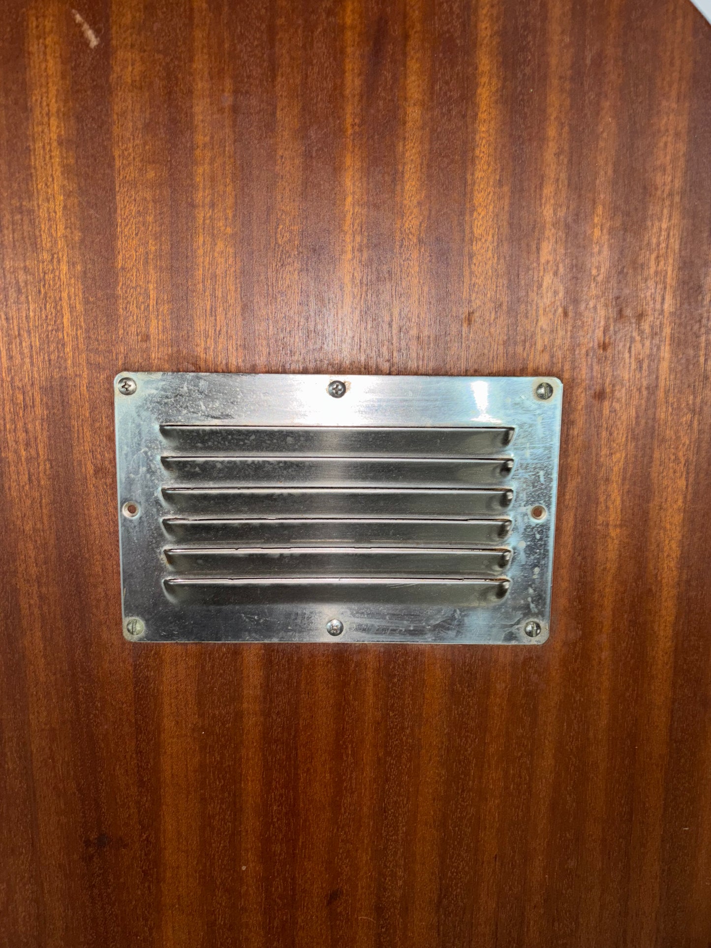 Metal vent on a wooden surface